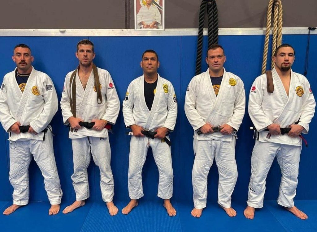 Nate Ellery (left) black belt promotion group photo with Alex Prates (middle)